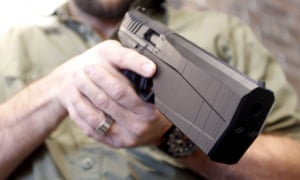 SilencerCo CEO Joshua Waldron holds the new Maxim 9 handgun with a built-in suppressor in West Valley City, Utah February 23, 2016. Gun silencers or suppressors, the accessory of Hollywood hit men, are becoming increasingly popular in the real world as hunters and other gun owners adopt them for hearing protection. REUTERS/Jim Urquhart