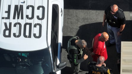 Gregory Rodriguez leading a prisoner out of a police car