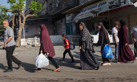 Palestinians carrying their belongings flee to safer areas in Gaza.