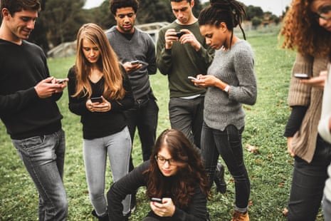 A group of young people on their phones