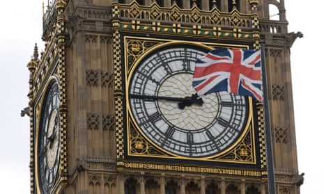 A Union flag flapping in the wind in front of Big Ben.