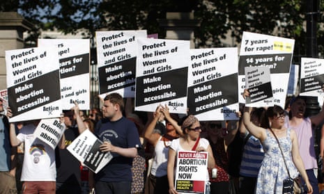 Pro-choice supporters hold placards at a protest