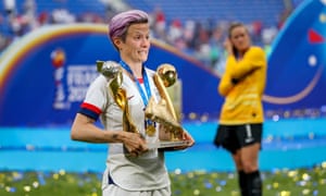 Megan Rapinoe celebrates with the World Cup trophy, the Golden Boot and the trophy for best player in the tournament.