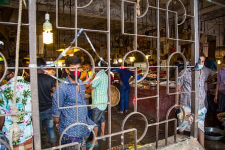 Masked shoppers in a Dhaka market