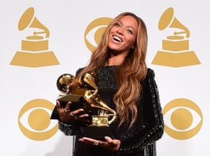 Beyoncé poses with the three Grammys she won at the awards in 2015, which took her tally of gongs to 20.