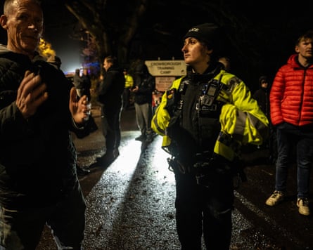 Police and protesters hold discussions on a dark roadside