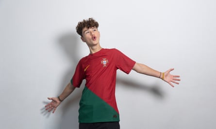 Gabriel Almeida with his arms outstretched, wearing a red-and-green Portugal shirt