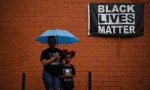 Mother and daughter Brittany and Brooklyn Elmore pose in Houston, Texas, for a portrait in front of a mural of George Floyd ahead of the anniversary last year of Floyd’s death. Floyd had moved from Texas to Minnesota before his death.