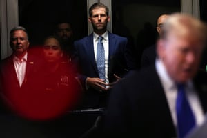 Eric Trump listens as his father, former president Donald Trump, speaks as he arrives at Manhattan criminal court on Thursday.
