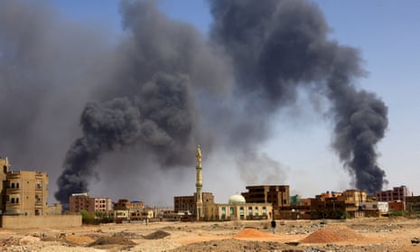 Smoke rises above buildings after airstrikes in north Khartoum on Monday.