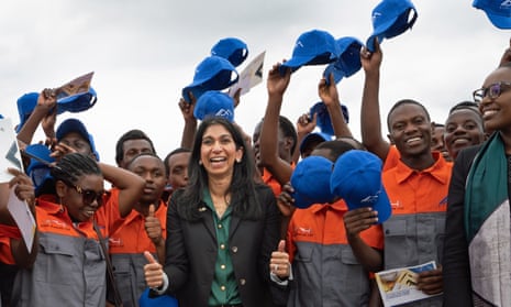 Suella Braverman with construction workers in Kigali, Rwanda, who will be constructing buildings for deported migrants from the UK. 