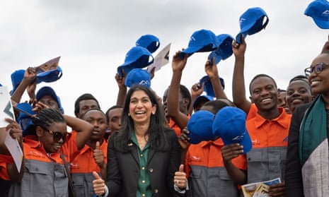 Suella Braverman in Kigali, Rwanda, in March, with workers who were planning to construct houses for deported migrants from the UK.