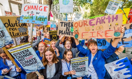 School pupils in central London holding placards as they take part in the Global Strike for Climate Justice, organised by Extinction Rebellion, Greenpeace and other groups in September 2019.