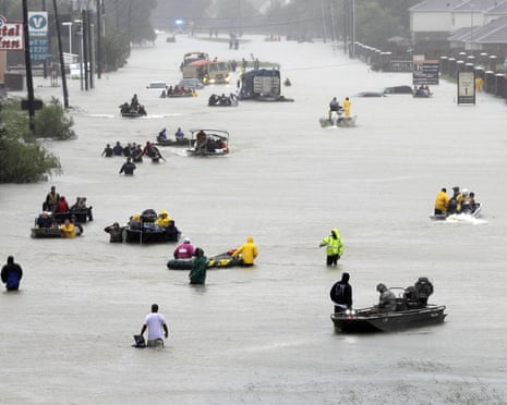 Flood evacuees\<br\>FILE - In this Aug. 28, 2017, file photo, rescue boats float on a flooded street as people are evacuated from rising floodwaters brought on by Tropical Storm Harvey in Houston. The National Hurricane Centerâs official report on Harvey compiles staggering numbers, starting with 68 dead and \$125 billion in damage. But the really big numbers in the Thursday, Jan. 25, 2018, tally have to do with the rainfall that swamped Houston. Two places had more than five feet of rain. Eighteen different parts of Texas logged more than four feet of rain. (AP Photo/David J. Phillip, File)