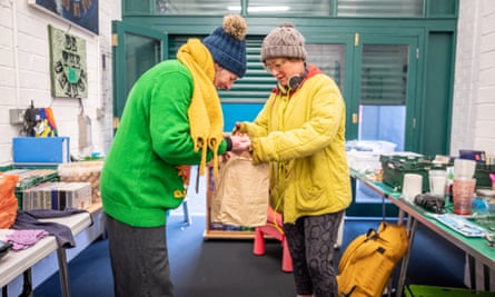 Freegle's Kate Fletcher (Green Jumper) looks at Catherine Fisher's donation.