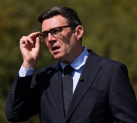 Andy Burnham adjusts his glasses