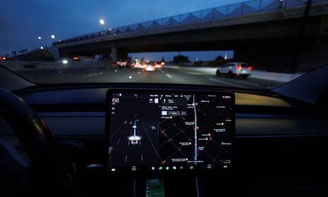 Tesla Model 3 drives on autopilot along California freeway.