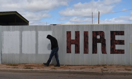 Man walks past sign saying 'Hire'