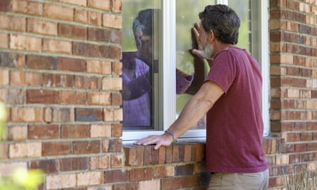 A man talks with his mother through a window at a nursing home in Windsor, Connecticut, in May 2020.