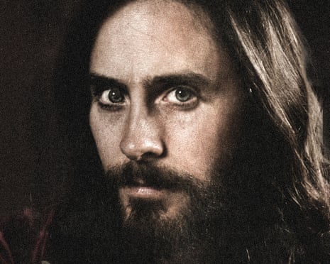 A man with long dark hair and a beard and moustache