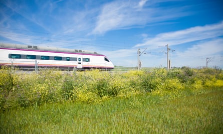 A high-speed train flies through the Spanish countryside