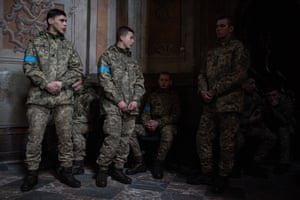 Ukrainian servicemen seen during the funeral service for four men who died in an airstrike in Lviv, Ukraine