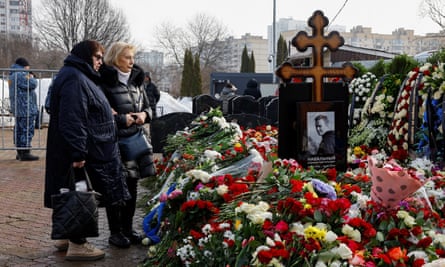 Lyudmila Navalnaya, left, the mother of late Russian opposition leader Alexei Navalny, comes to the grave of her son following a funeral at the Borisovskoye cemetery in Moscow.