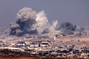 Smoke billows after Israeli strikes, with destroyed buildings in the foreground