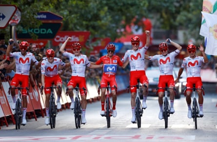 Mas crosses the finish line in Granada arm-in-arm with his six Movistar teammates.