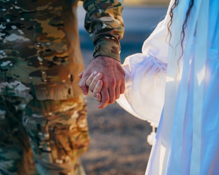 Tetiana and Oleksandr hold hands.
