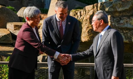 Penny Wong shakes hands with Li Qiang as Peter Malinauskas looks on
