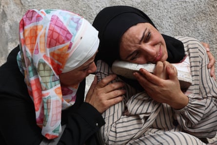 Woman cries and holds shoe of loved one