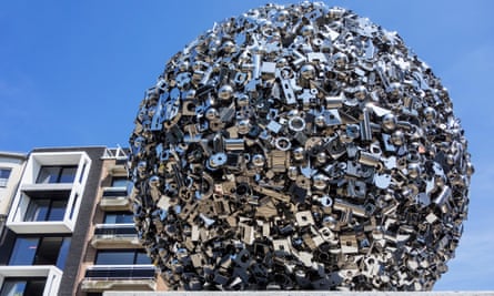 A large sphere made out of variously shaped silvery metal objects