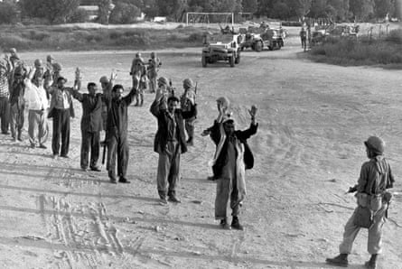 An Israeli soldier lines up captured Egyptian troops to be checked for identification in the Gaza Strip, in June 1967.