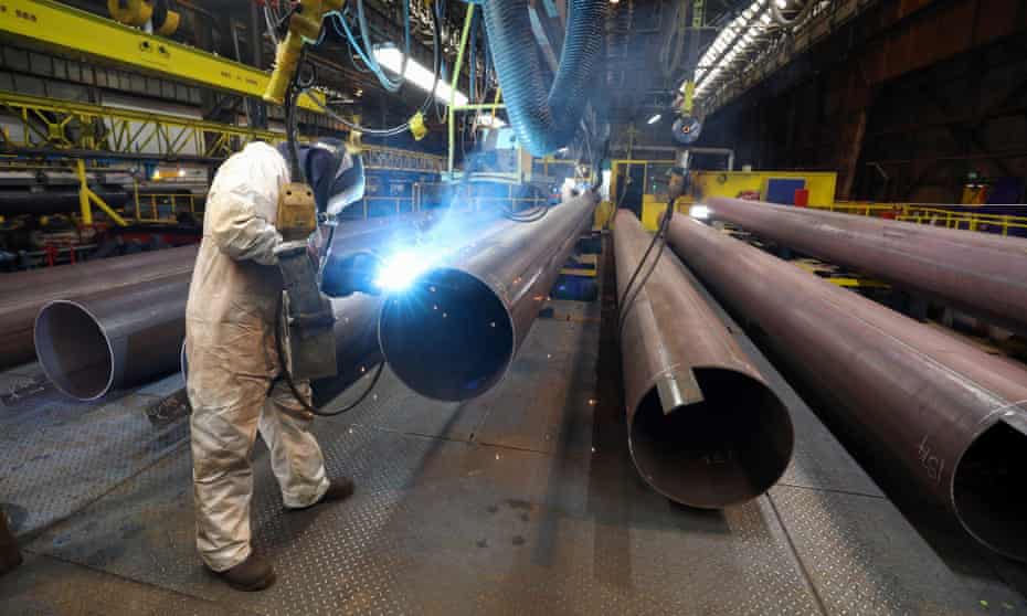 An employee welds the joint on a steel pipe at the SAW pipe mills, operated by Liberty Steel in Hartlepool