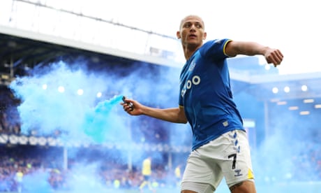 Everton’s Richarlison celebrates with a flare in his right hand after scoring in the 46th minute