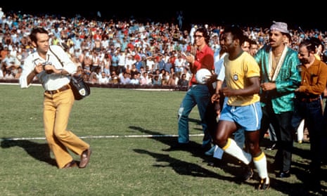 Pelé is surrounded by photographers before the 1970 World Cup final between Brazil and Italy.