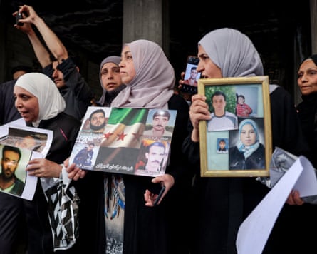 A group of women holding photographs.