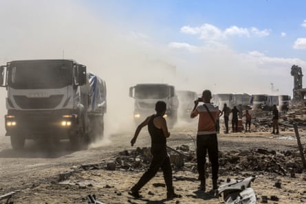 Trucks carrying food aid and fuel, accompanied by a United Nations team, pass through the Kerem Shalom border crossing on Wednesday.