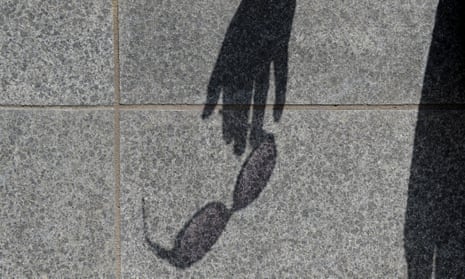 Shadow of a hand holding sunglasses