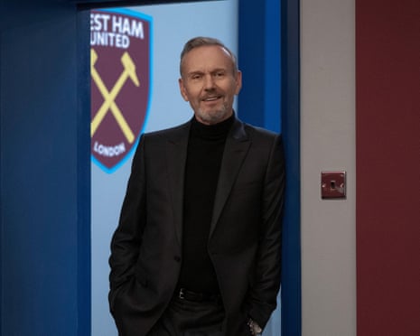 a man leans against a door frame