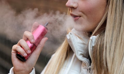 A young woman vaping
