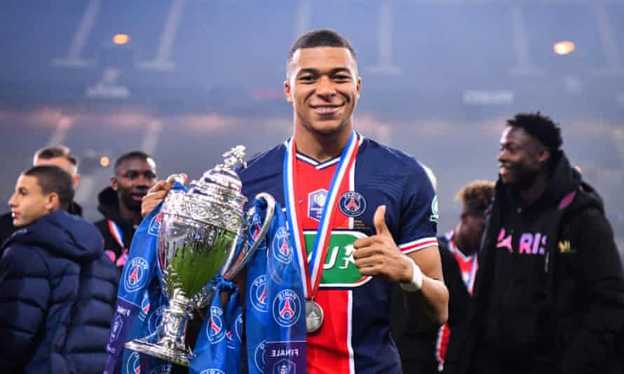 Kylian Mbappé holds the French Cup trophy after powering PSG to victory over Monaco.