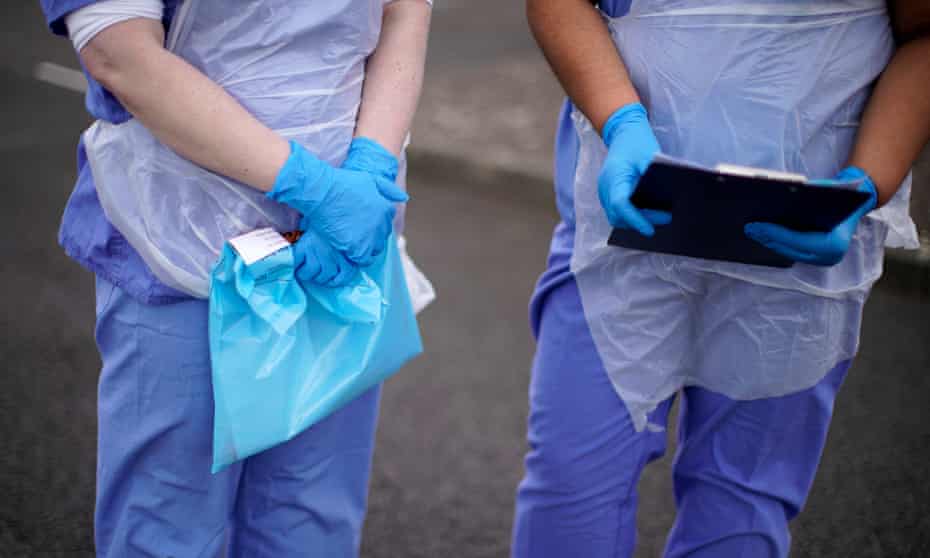 An NHS nurse holds a Coronavirus testing kit at a drive-through coronavirus testing site in a car park on March 12, 2020 in Wolverhampton.