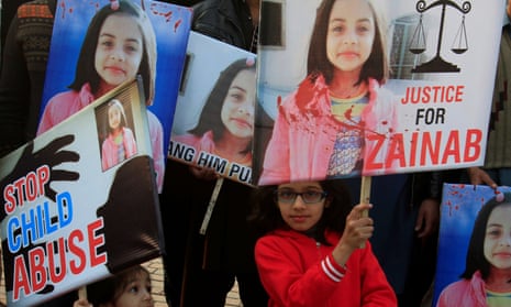 A girl holds a sign as she chants slogans with others to condemn the rape and killing of seven-year-old Zainab Ansari.