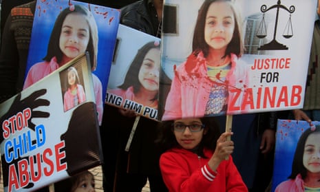 Girls hold placards at a protest in Lahore against the rape and murder of Zainab Ansari.