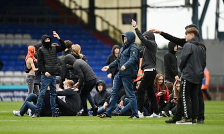 Oldham supporters halt the game at home to Barrow this month by invading the pitch.