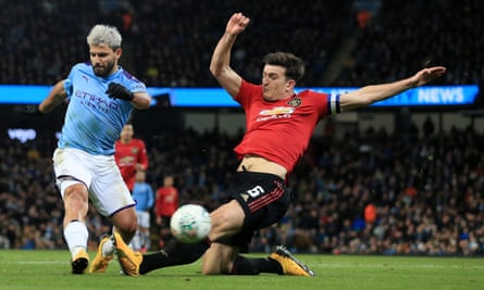 Harry Maguire attempts to block a shot from Sergio Agüero during the Carabao Cup semi-final.