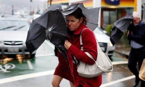 Pedestrians shield themselves from the wind and rain during a storm in Wellington. 
