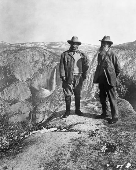 Theodore Roosevelt stands with naturalist John Muir on Glacier Point, above Yosemite Valley in California.